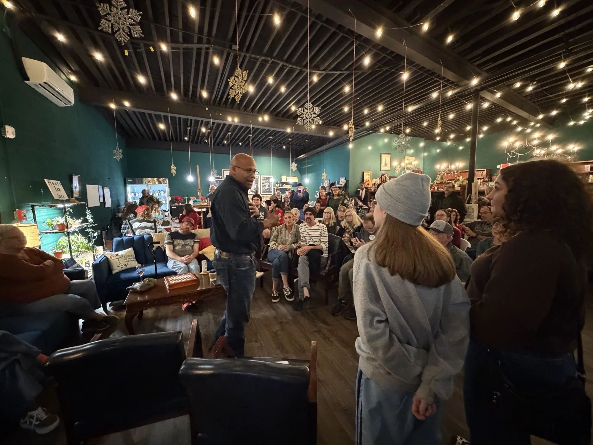 Shawn Harris listening to a constituent at a coffee shop town hall