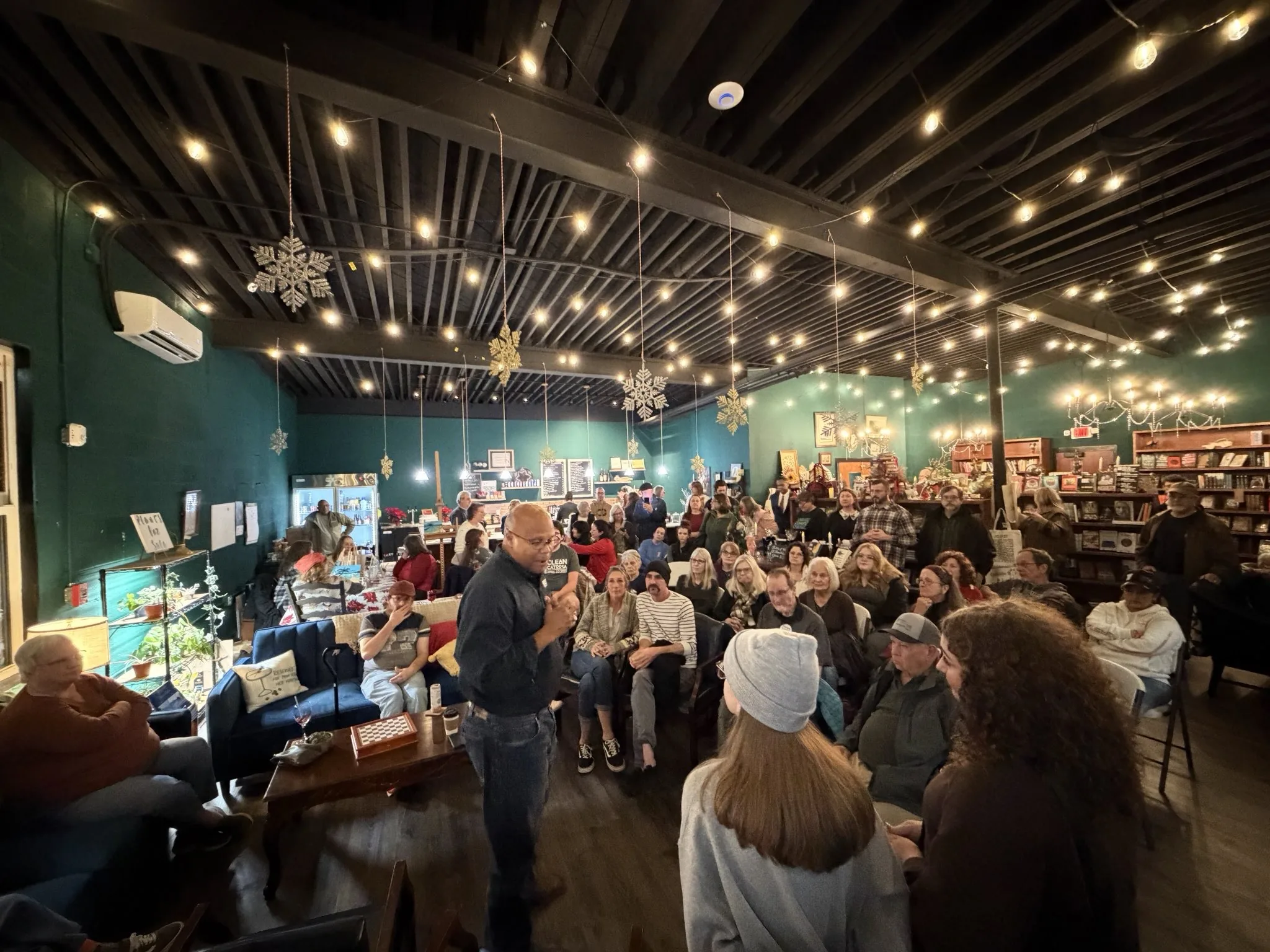 Shawn Harris speaking with Northwest Georgia residents at a coffee shop town hall