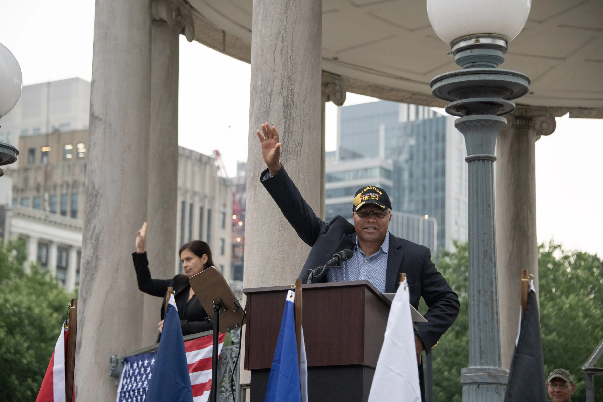 Shawn Harris speaking at a D-Day ceremony podium