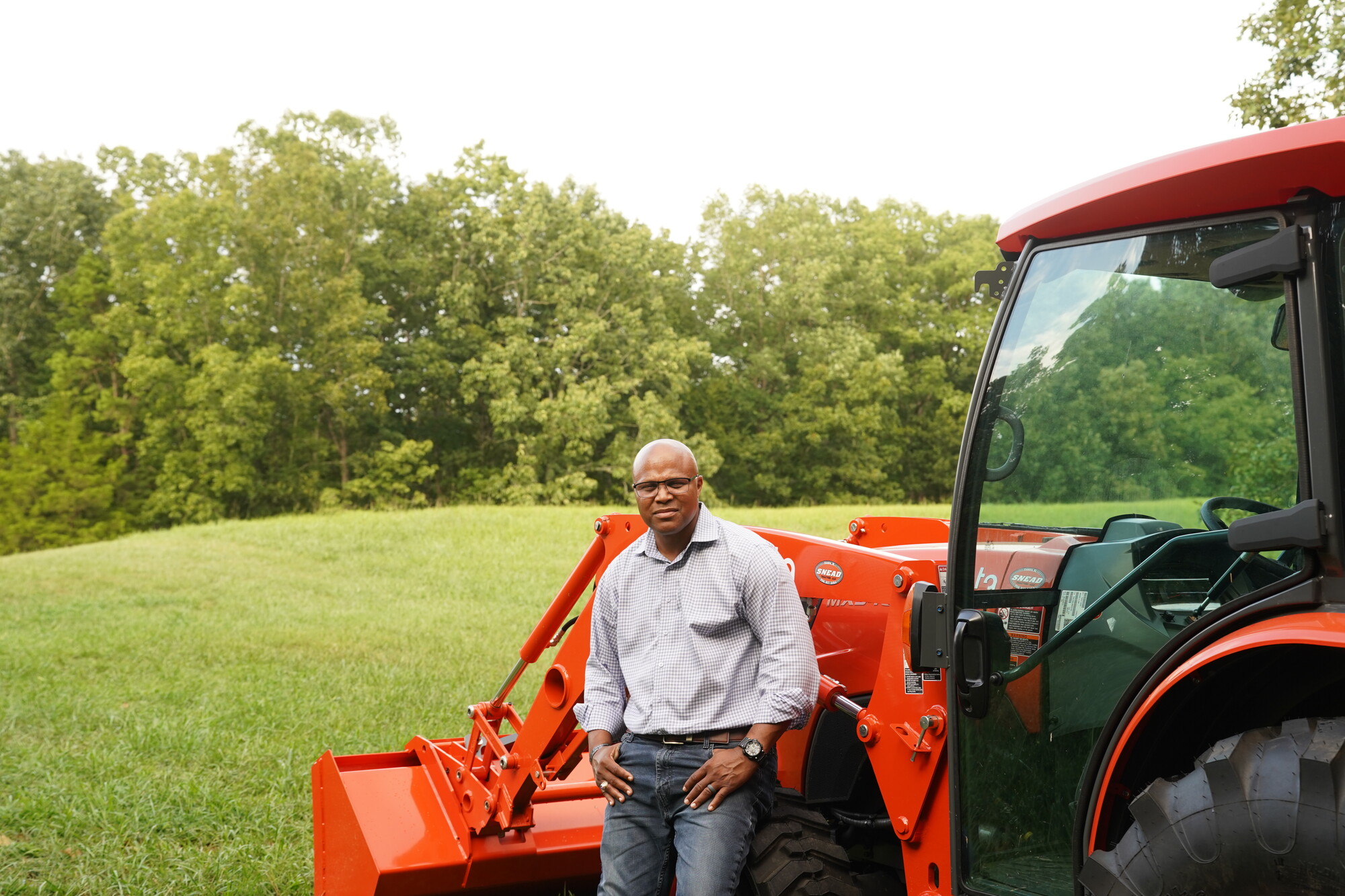 Shawn Harris standing beside a tractor